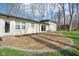 A backyard patio features professionally installed pavers bordered with stone and the back of the home at 11921 Westwood Dr, Carmel, IN 46033