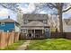 View of the backyard showing the fenced yard and deck of the two-story home at 1230 N Temple Ave, Indianapolis, IN 46201