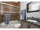 Well-lit bathroom with a bathtub/shower combination and a vanity with a sink at 1230 N Temple Ave, Indianapolis, IN 46201