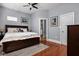 Cozy bedroom with a dark wood bed frame, hardwood floors, and ensuite bathroom access at 1230 N Temple Ave, Indianapolis, IN 46201