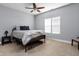 Clean bedroom with a bed, bedside table, neutral walls, and ample natural light at 1230 N Temple Ave, Indianapolis, IN 46201