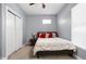 Bedroom with a cozy bed, bedside table, closet, and plush carpet at 1230 N Temple Ave, Indianapolis, IN 46201