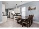 Bright kitchen and dining area with white cabinets, stainless steel appliances, and modern lighting at 1230 N Temple Ave, Indianapolis, IN 46201