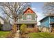 Charming two-story home featuring a brick foundation, cozy porch, and inviting exterior at 1230 N Temple Ave, Indianapolis, IN 46201