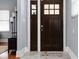 Elegant front door with glass accents, sidelights, and a welcoming doormat at 1230 N Temple Ave, Indianapolis, IN 46201