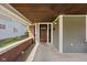 Inviting front porch with brick accents, a stained wood ceiling, and ample space at 1230 N Temple Ave, Indianapolis, IN 46201
