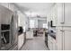 Modern kitchen with white cabinets, stainless steel appliances, and an open layout at 1230 N Temple Ave, Indianapolis, IN 46201