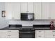 Modern kitchen with white cabinets, subway tile backsplash, and stainless steel appliances at 1230 N Temple Ave, Indianapolis, IN 46201