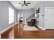 Open living space featuring hardwood floors, a ceiling fan, and a staircase at 1230 N Temple Ave, Indianapolis, IN 46201