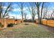 Spacious backyard featuring a wooden fence, trees and a shed at 1337 Linden St, Indianapolis, IN 46203