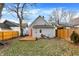 View of backyard featuring a wooden deck, a partially fenced yard and home exterior with gray siding at 1337 Linden St, Indianapolis, IN 46203