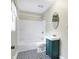 This bathroom showcases patterned floors and a vintage vanity that complements the shower-tub combo at 1337 Linden St, Indianapolis, IN 46203