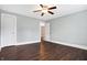 Bright bedroom featuring a ceiling fan, hardwood floors, and a doorway leading to another room at 1337 Linden St, Indianapolis, IN 46203