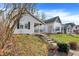 Charming two-story home with light siding, front porch, landscaped yard and a concrete stairway at 1337 Linden St, Indianapolis, IN 46203