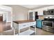 The kitchen features stainless steel appliances and a central island, perfect for cooking and entertaining at 1337 Linden St, Indianapolis, IN 46203