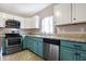 Bright kitchen with stainless steel appliances, blue base cabinets and white overhead cabinets at 1337 Linden St, Indianapolis, IN 46203