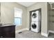 This functional laundry room features a stacked washer and dryer with an adjacent vanity for added convenience at 1337 Linden St, Indianapolis, IN 46203
