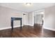 Living room area with neutral colored walls, dark wood flooring, and a decorative fireplace mantel at 1337 Linden St, Indianapolis, IN 46203