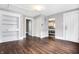 Living room showcasing hardwood floors, built-in shelving, and an open layout leading to the kitchen and front door at 1337 Linden St, Indianapolis, IN 46203