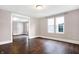 Open living room area featuring hardwood floors, natural light from the windows, and an open doorway at 1337 Linden St, Indianapolis, IN 46203