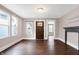 Bright living room featuring hardwood floors, large windows, a decorative fireplace, and an open floor plan at 1337 Linden St, Indianapolis, IN 46203