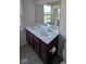 Well-lit bathroom vanity featuring a double sink and a large mirror, plus a view to the outside at 13872 N Mardenis W Dr, Camby, IN 46113