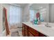 Well-lit bathroom with double vanity, patterned shower curtain, and tiled floors at 13872 N Mardenis W Dr, Camby, IN 46113