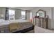 Light filled bedroom features neutral walls, carpet, and an ornate dresser and mirror at 13872 N Mardenis W Dr, Camby, IN 46113