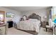 Primary bedroom features a large bed, TV, sitting area, and neutral decor at 13872 N Mardenis W Dr, Camby, IN 46113