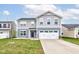 Charming two-story home with a two-car garage, manicured lawn and inviting curb appeal at 13872 N Mardenis W Dr, Camby, IN 46113