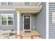 Charming front entrance with muted blue siding, white trim, and a welcoming black door at 13872 N Mardenis W Dr, Camby, IN 46113