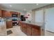 Well-lit kitchen features stainless steel appliances, center island, tile backsplash, and abundant cabinet space at 13872 N Mardenis W Dr, Camby, IN 46113