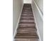 Staircase with hardwood steps, white risers and handrail, providing a modern transition between floors at 13872 N Mardenis W Dr, Camby, IN 46113