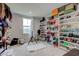Spacious walk-in closet has custom built-in shelving, carpeting, and a window at 13872 N Mardenis W Dr, Camby, IN 46113