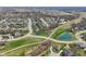 An aerial shot showcases a serene residential area with ponds and lush green spaces at 14747 Harvest Glen S Blvd, Fishers, IN 46037