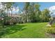 Large backyard with beautiful green grass and mature trees at 14747 Harvest Glen S Blvd, Fishers, IN 46037