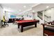 Large finished basement with a pool table, living area, bar and staircase to the upper level at 14747 Harvest Glen S Blvd, Fishers, IN 46037