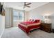 Bright bedroom featuring plush carpeting, large windows, and a ceiling fan at 14747 Harvest Glen S Blvd, Fishers, IN 46037