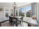 Sun-filled dining room features a modern table, backyard views, and elegant furnishings at 14747 Harvest Glen S Blvd, Fishers, IN 46037