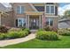 Stunning brick home with vibrant landscaping and a welcoming entrance at 14747 Harvest Glen S Blvd, Fishers, IN 46037
