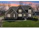 Elegant home with brick facade, well-kept lawn, and professionally landscaped garden beds at 14747 Harvest Glen S Blvd, Fishers, IN 46037