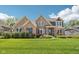 Charming brick home with manicured lawn, beautiful landscaping, and classic architectural details at 14747 Harvest Glen S Blvd, Fishers, IN 46037