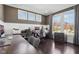 Well-lit home office showcasing hardwood floors, a gray color scheme, and built-in desks with wainscoting at 14747 Harvest Glen S Blvd, Fishers, IN 46037
