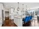 Bright kitchen boasts an island with granite countertops, white cabinets, and stainless steel appliances at 14747 Harvest Glen S Blvd, Fishers, IN 46037