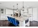 The kitchen features a granite island with seating, white cabinets, and stainless steel appliances at 14747 Harvest Glen S Blvd, Fishers, IN 46037