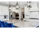 Close-up of a kitchen island with granite countertops, pendant lights, and white cabinets at 14747 Harvest Glen S Blvd, Fishers, IN 46037