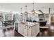 Spacious kitchen with an island featuring a granite countertop, view to the fireplace, and a breakfast nook at 14747 Harvest Glen S Blvd, Fishers, IN 46037