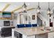 Kitchen island with seating overlooks a fireplace and a staircase at 14747 Harvest Glen S Blvd, Fishers, IN 46037