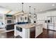 Kitchen features an island with breakfast bar, stainless steel appliances, and hardwood floors at 14747 Harvest Glen S Blvd, Fishers, IN 46037