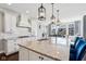 Kitchen with a granite countertop island, white cabinets, and stainless steel appliances overlooking the breakfast nook at 14747 Harvest Glen S Blvd, Fishers, IN 46037